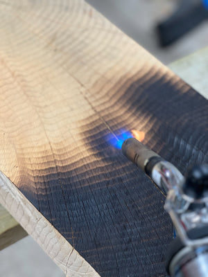 Cut being prepared for relief using Shou Sugi Ban